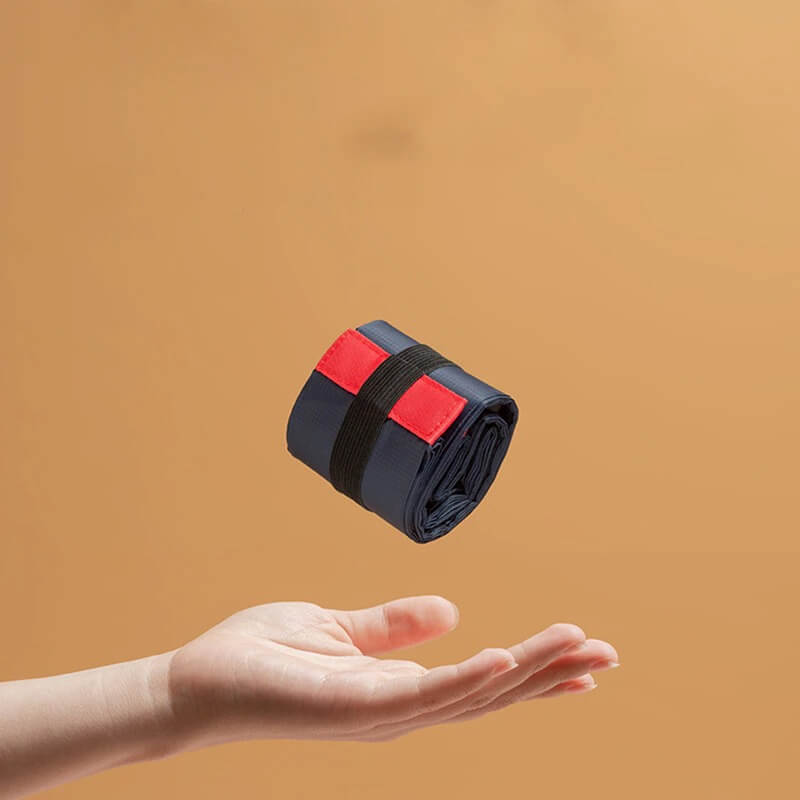 Compact waterproof sports shoulder bag SF0671, lightweight for active women, features rolled-up navy and red design hovering above a hand.